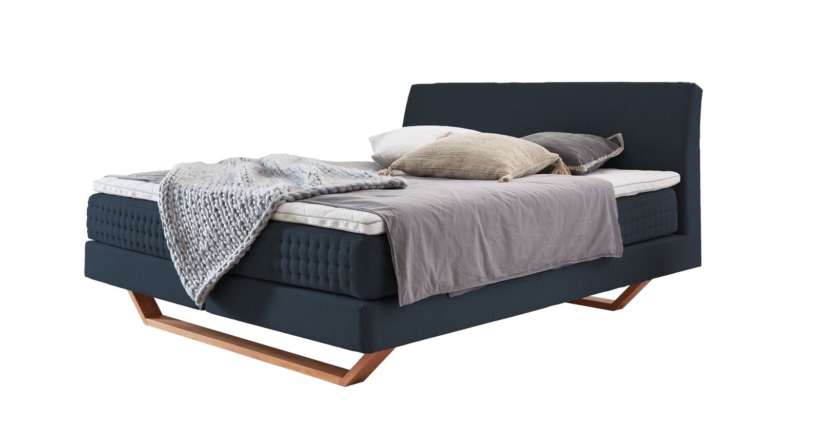 Das Boxspringbett "Clarice" im modernen Material-Mix - hier mit petrolfarbenem Webstoffbezug.