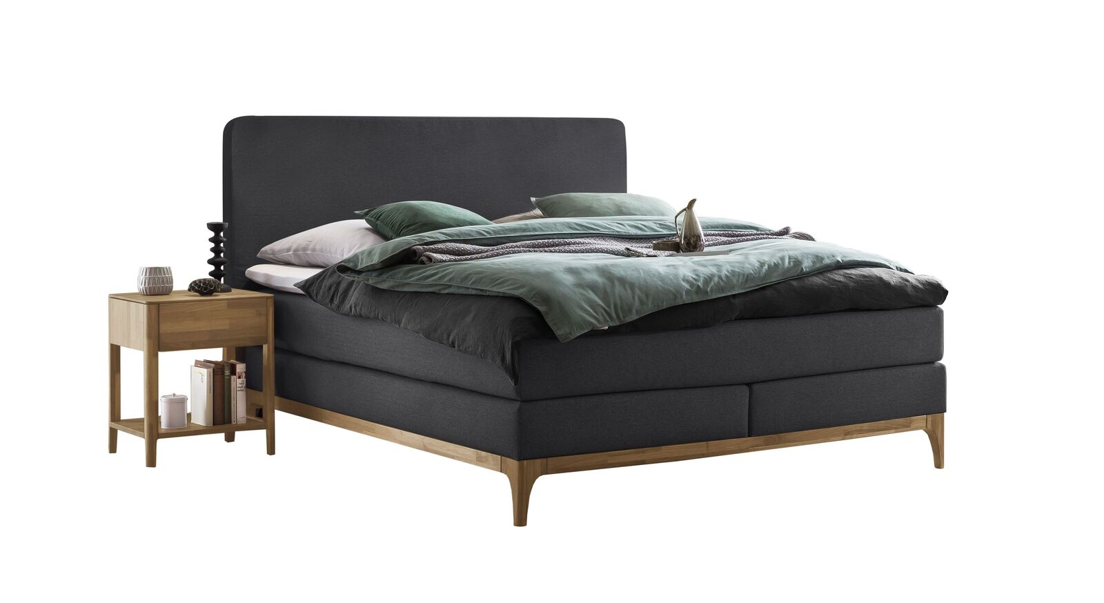 Hell geölter Sockel aus Eichenholz und dunkler Stoffbezug: das Boxspringbett "Conrado" in Anthrazit.