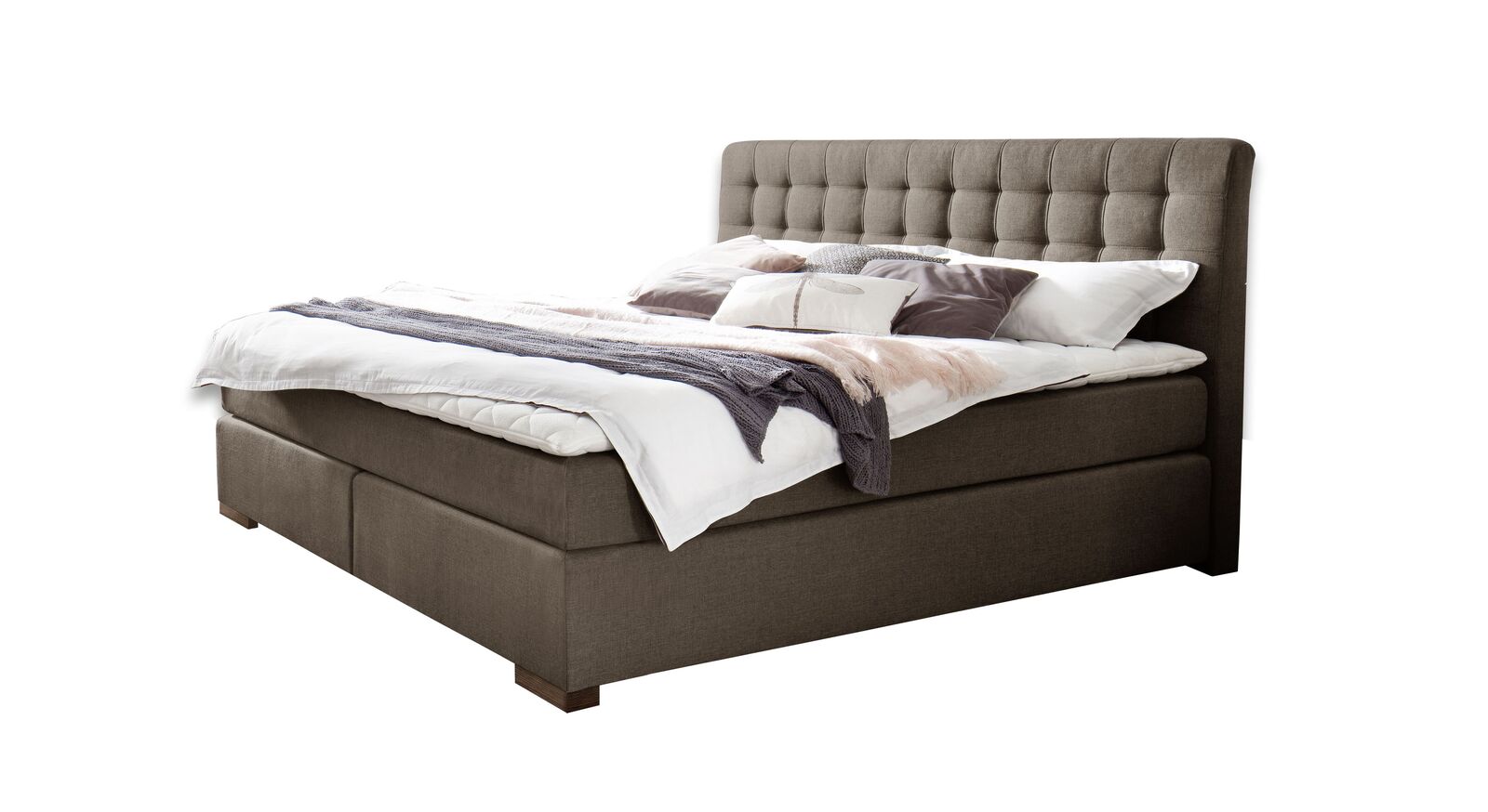 Ein weicher, melierter Webstoffbezug umhüllt das gesamte Boxspringbett "Matai".