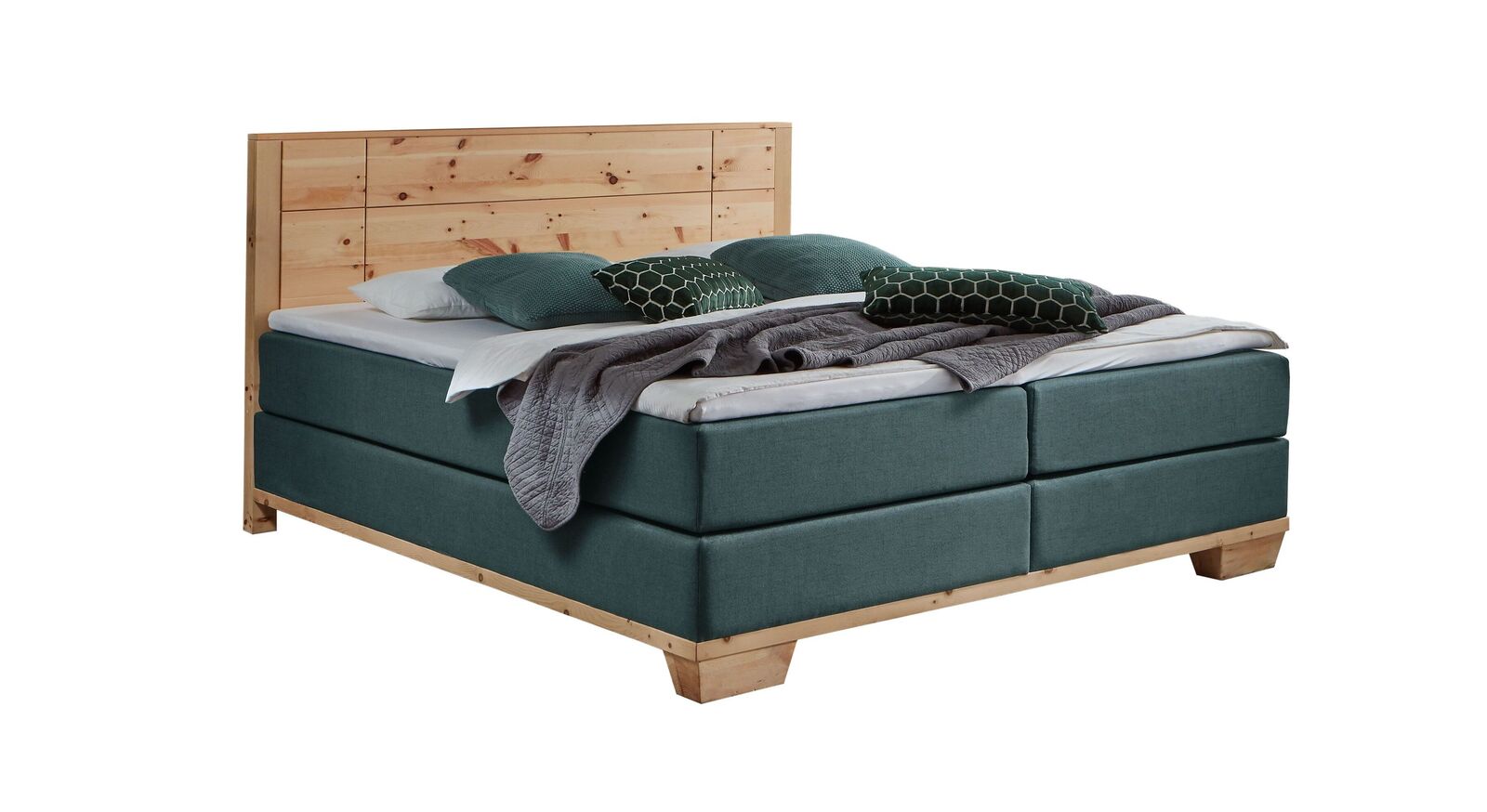 Das markante Boxspringbett "Sinestra" im modernen Materialmix – hier mit petrolfarbenem Stoffbezug.