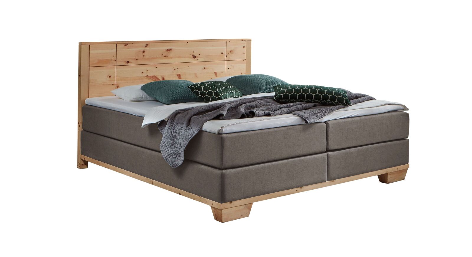 Das markante Boxspringbett "Sinestra" im modernen Materialmix – hier mit taupefarbenem Stoffbezug.