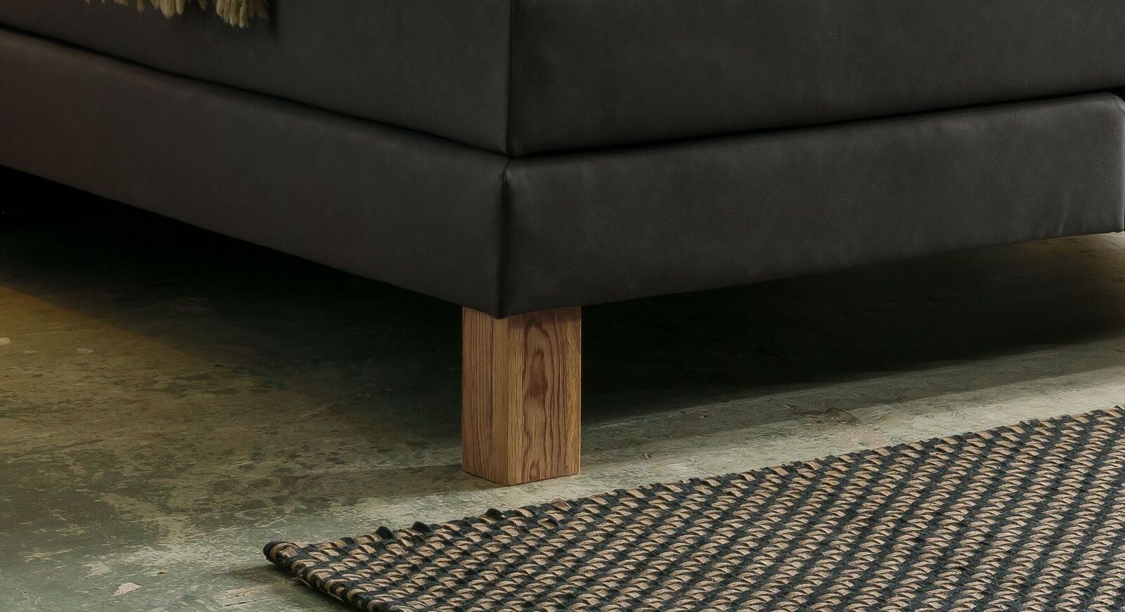 Die kantigen Bettbeine aus Wildeichenholz passen perfekt zu dem klassischen Gesamtlook und dem auffälligen Kopfteil.