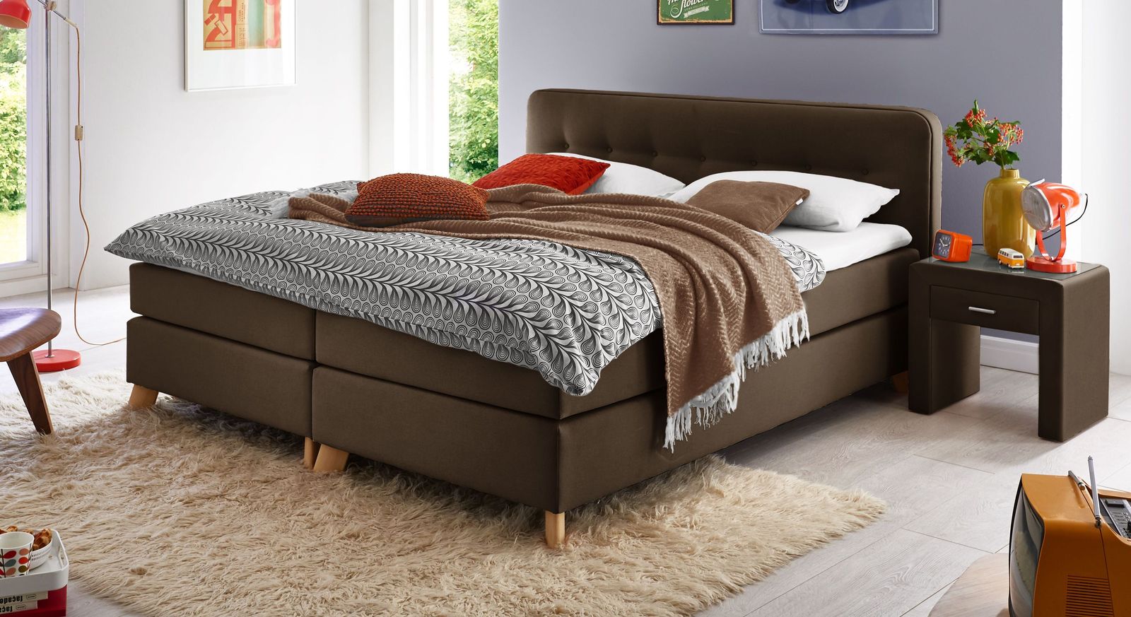 Der braune Bezugsstoff verleiht dem Bett (hier 53 cm) eine warme und einladende Note.