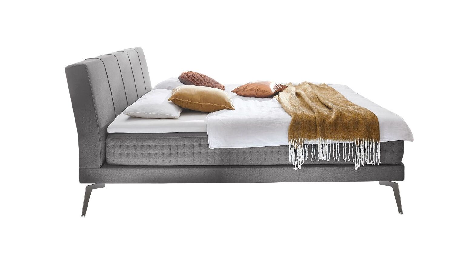 Die Matratze des Boxspringbettes ist seitlich mit Stoff bezogen und mit einer aufwendigen Punktsteppung versehen.