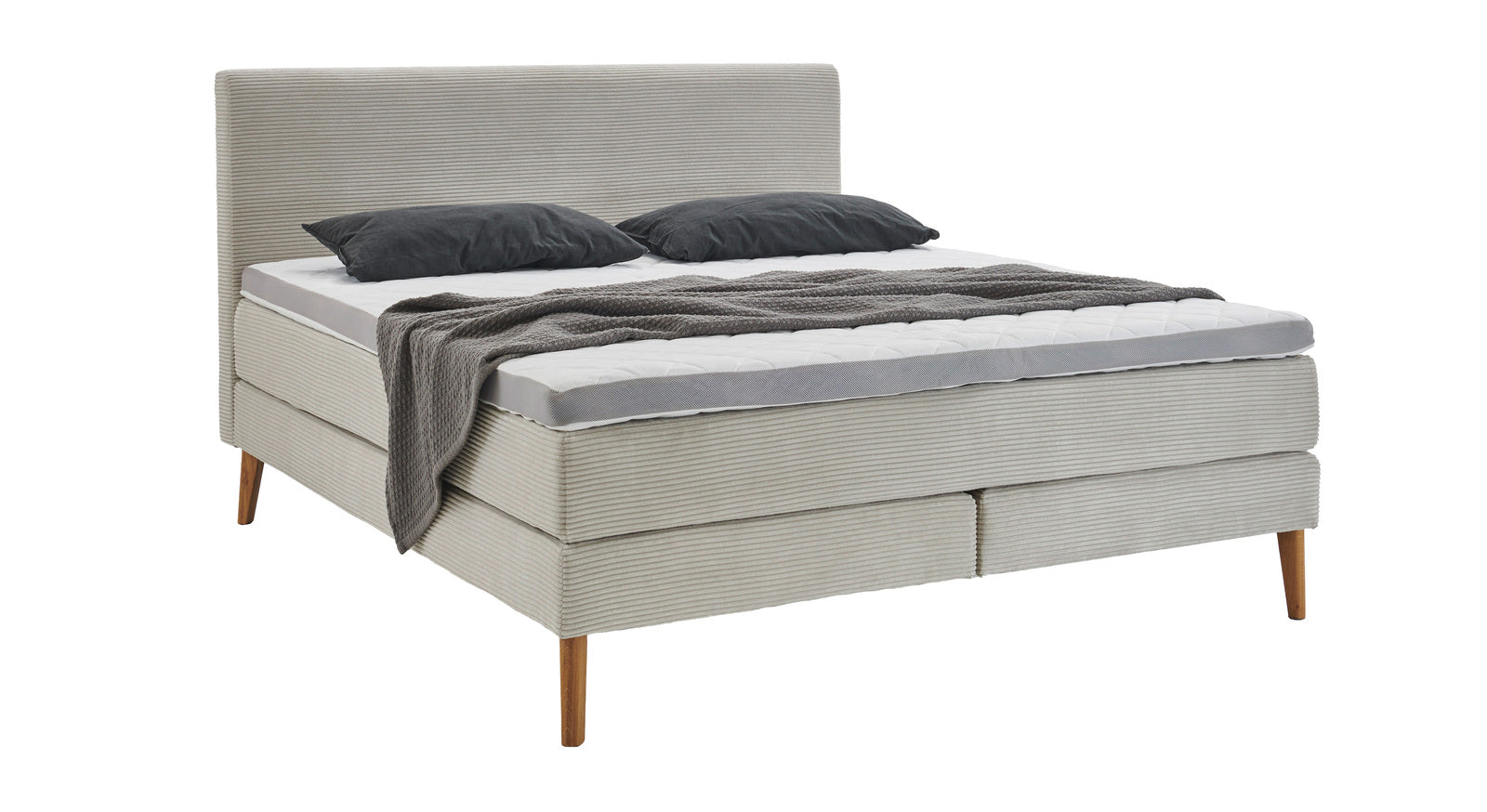 Viel Komfort f&uuml;r kleines Geld: Das Boxspringbett "Haland" mit beigefarbenem Cordbezug (hier inkl. Topper).