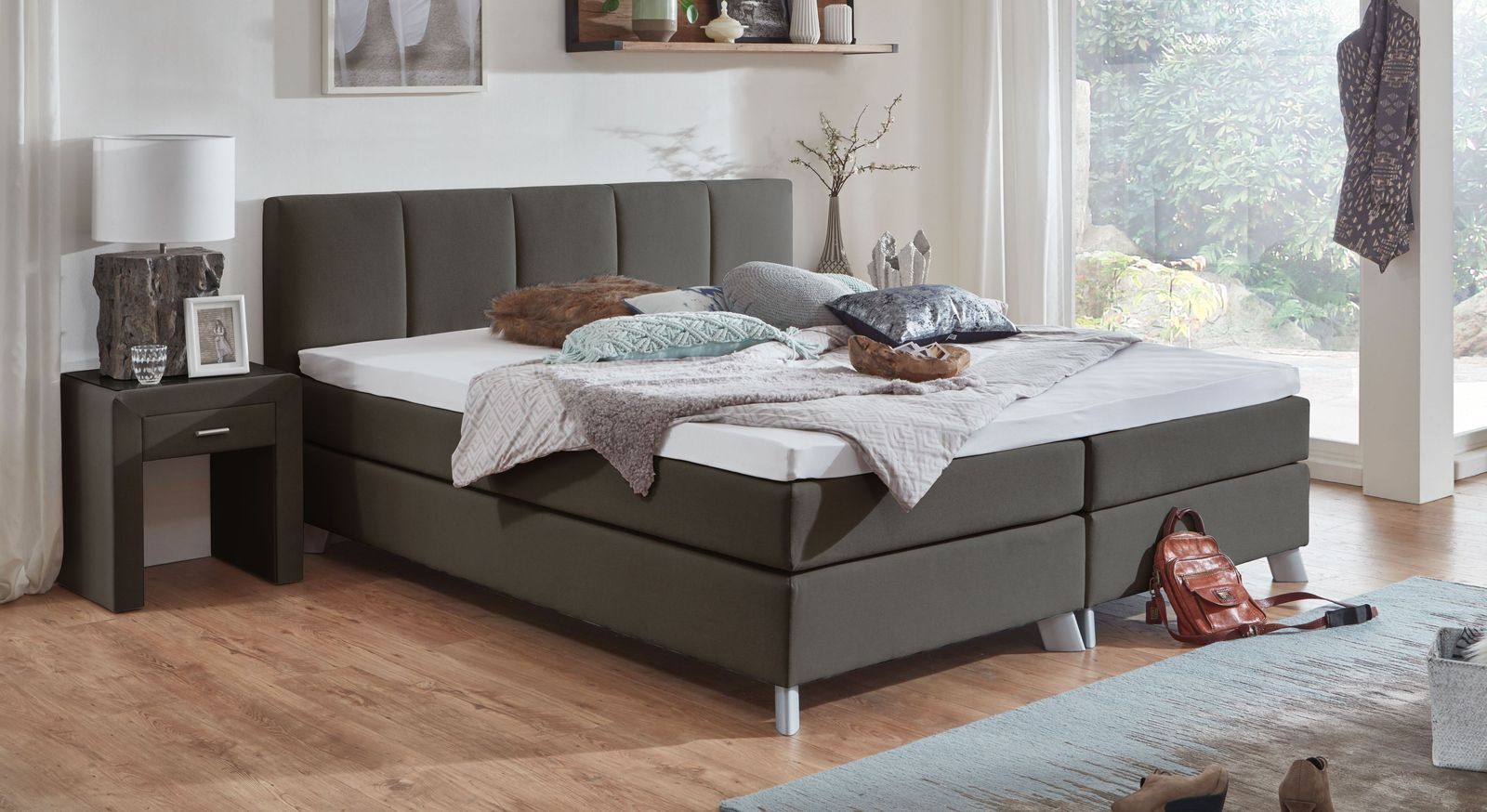 Geschmackvoller Kontrast: das 53 cm hohe Boxspringbett "Ramea" in Anthrazit mit silberfarbenen F&uuml;&szlig;en.